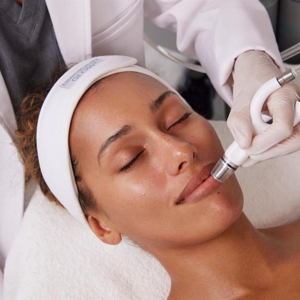 Woman receiving a DiamondGlow facial treatment