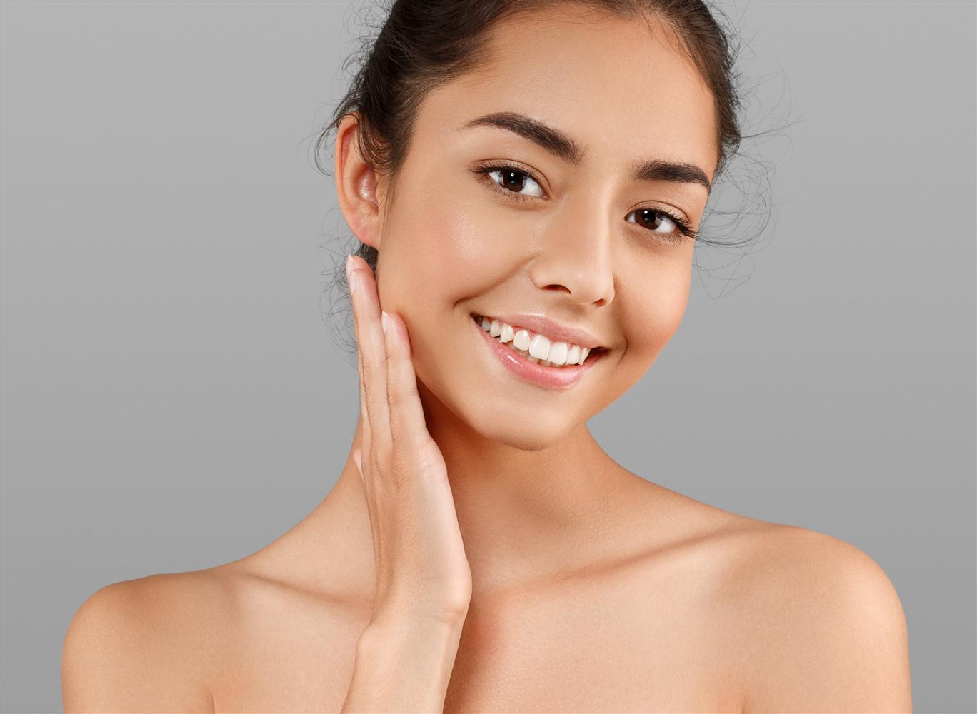 Smiling woman resting her hand against her cheek